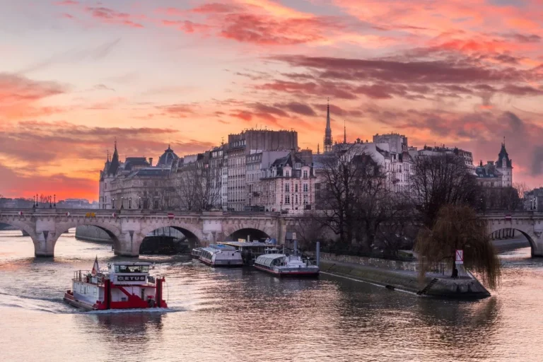 Anochecer sobre el río Sena con las luces de la ciudad reflejadas en el agua